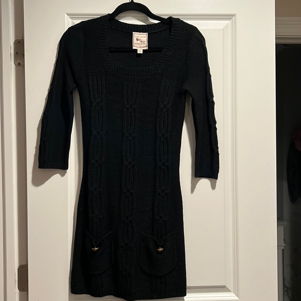 Black cable design sweater dress with pockets and gold accent buttons